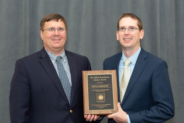 Kevin Harvatine, right, receives his award from Robert Roberts, head of the Department of Food Science and chair of the ADSA Foundation Board.