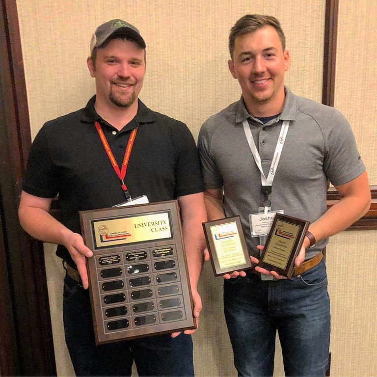 Dave Weaver, left, assistant manager of the Penn State Meat Laboratory, and Josh Cassar, graduate student, hold the trophies they won at the American Cured Meat Championship in Kansas City.