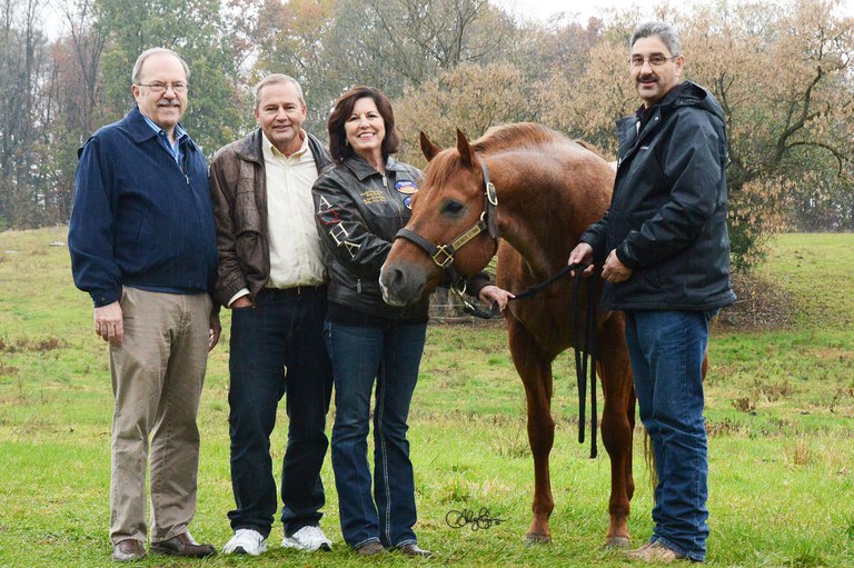 Surrounding "Irish," from left, are Dr. Terry Etherton, Head of the Department of Animal Science, Craig and Becky Bailey and Brian Egan, Horse Farm Coordinator.