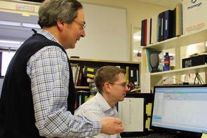 Kevin Harvatine, associate professor of nutritional physiology, seated, and Robert Elkin, professor of avian nutritional biochemistry, review study results.