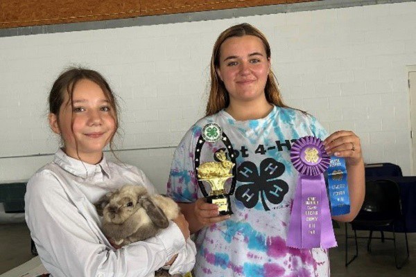 Piper Walker with her Best of Show Holland Lop, and Judge Tara Lander.