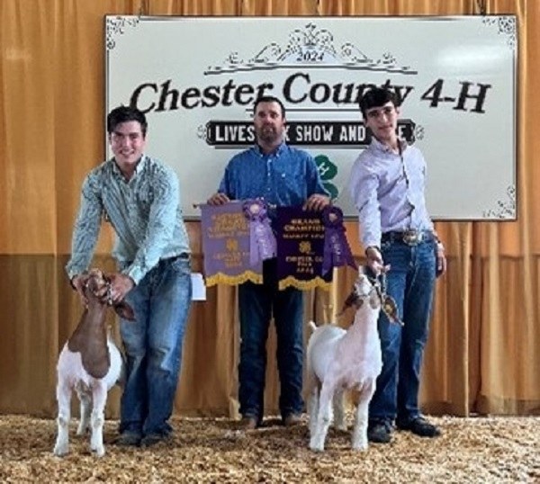 Chester County 4-H Market Goat Show Judge John Passwater of Bridgeville, DE and River Lease with Reserve Grand Champion Market Goat and Sawyer Lease holding the Grand Champion Goat.