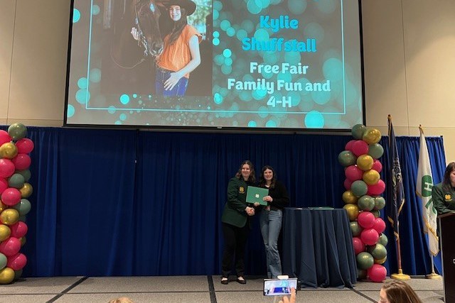 Crawford County 4-H Member Recognized for Diamond Clover Award Kylie receiving her Diamond Clover Award at SLC from a State 4-H Council member