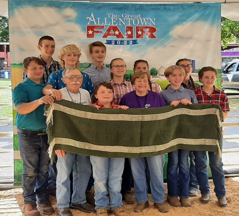 $1,700 Shawl Woven by Lehigh County 4-H Livestock Club Pictured: Lehigh County 4-H Livestock Club and Rodger & Nancy Bowman with completed woven wool shawl