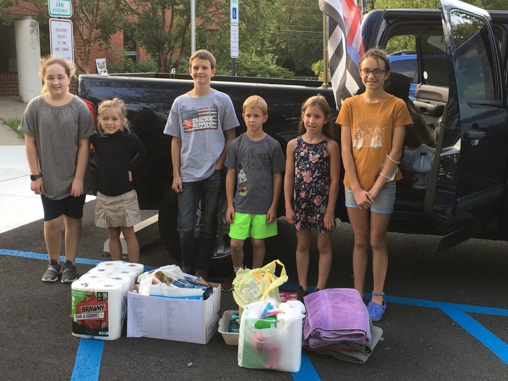4-H Club Donates to Humane Society Coop Club Members (L to R) Emily L, Quinly H, Konnor W, Alex W, Addison W, and Rosy N with some of their many donations for the Humane Society.